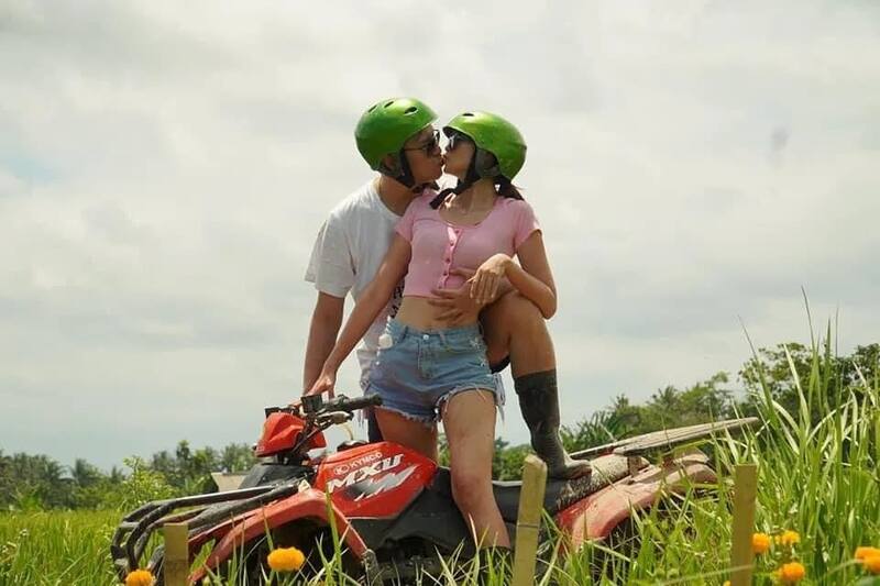 Couple Kissing On Red Atv Vehicle In Green Field