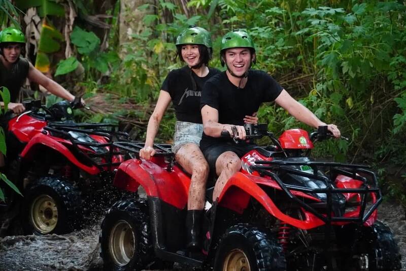 Couple Riding Red Atv Through Muddy Forest Trail