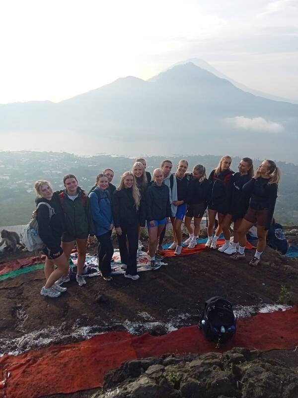 Group Of Hikers Posing With Mountain View Morning