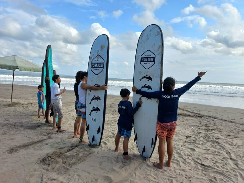 Group Of People Preparing For Surfing Lesson On Beach