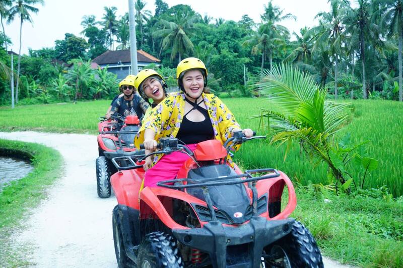 Group Of People Riding Red Atv Quad Bikes On Rural Path