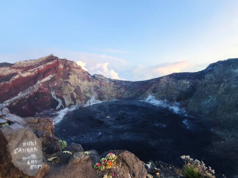 Mountain Volcano Crater With Smoke And Flower Offerings Sunset