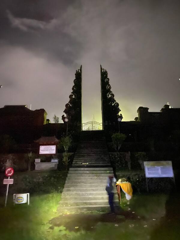 Nighttime Indonesian Temple Gate Staircase Mystical Glow Person