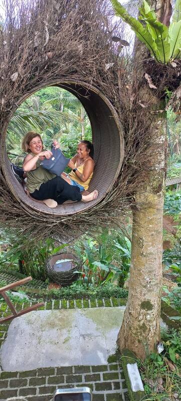 Two Women Sitting In Large Circular Tree Nest Happy Outdoor