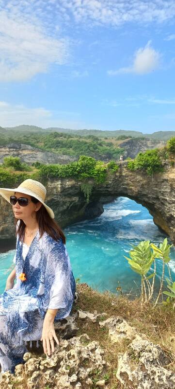 Woman In Sunhat Sunglasses Sitting Cliff Ocean Natural Rock Arch