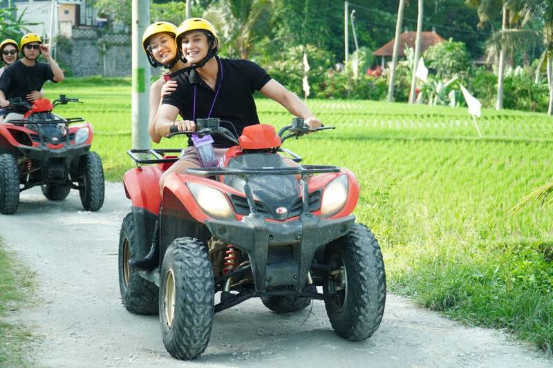 Young Couple Riding Red Atv On Country Road Green Fields